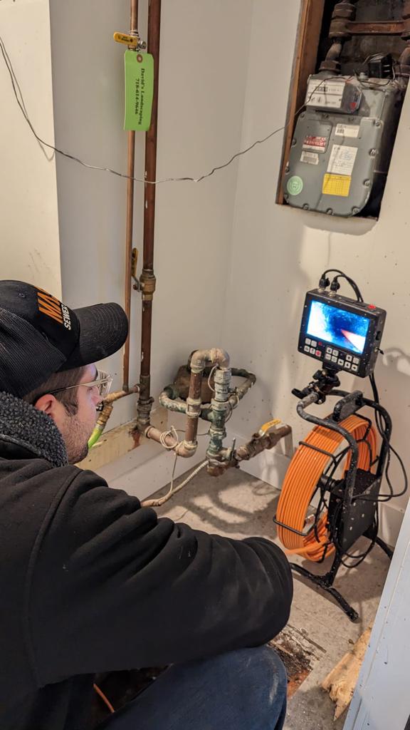 Technician performing a camera pipe inspection